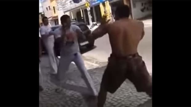Lone no-rules fighter vs. team of Capoeira fighters throw down on the streets of Brazil