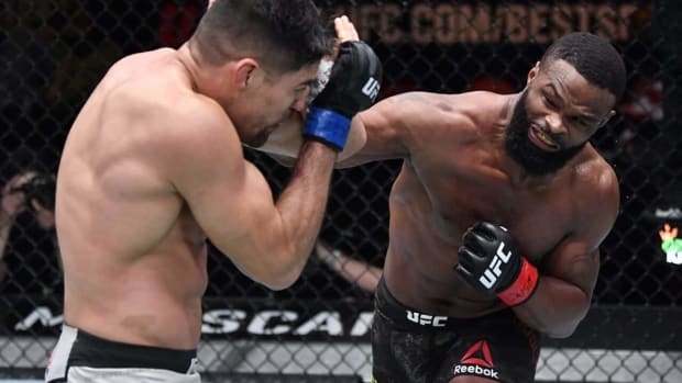 Mar 27, 2021; Las Vegas, NV, USA;    Tyron Woodley punches Vicente Luque in their welterweight fight during the UFC 260 event at UFC APEX on March 27, 2021 in Las Vegas, Nevada. Mandatory Credit: Jeff Bottari/Handout Photo via USA TODAY Sports