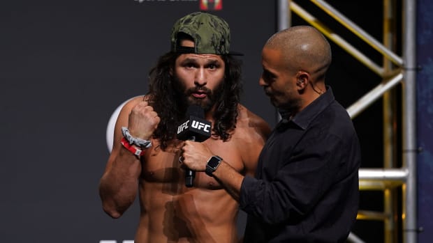 Jorge Masvidal (L) talks with UFC play-by-play commentator Jon Anik (R) during weigh-ins for UFC 261 at VyStar Veterans Memorial Arena.