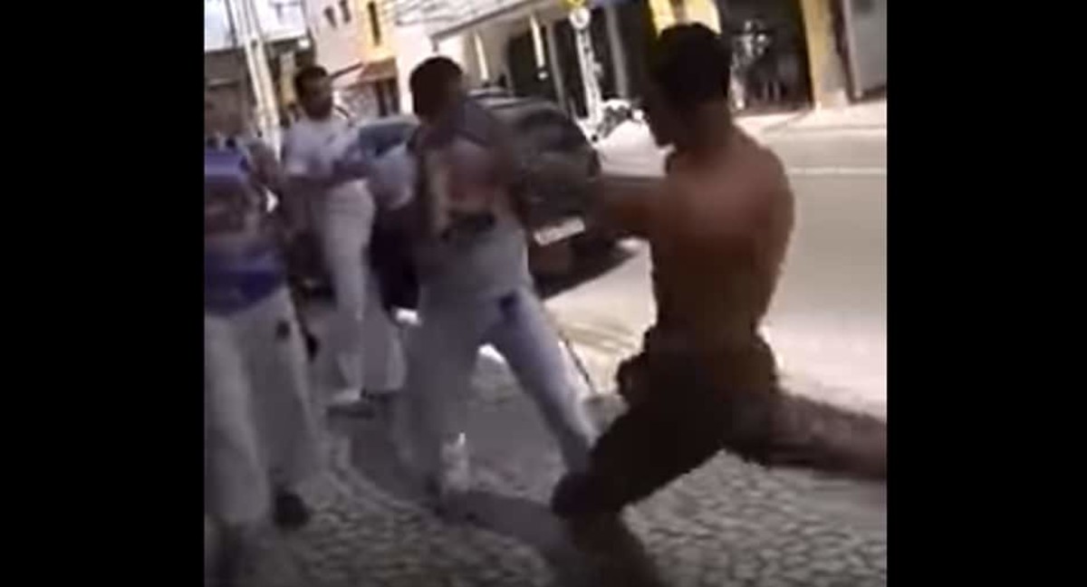 Muay Thai fighter vs. group of Capoeira fighters on streets of Brazil