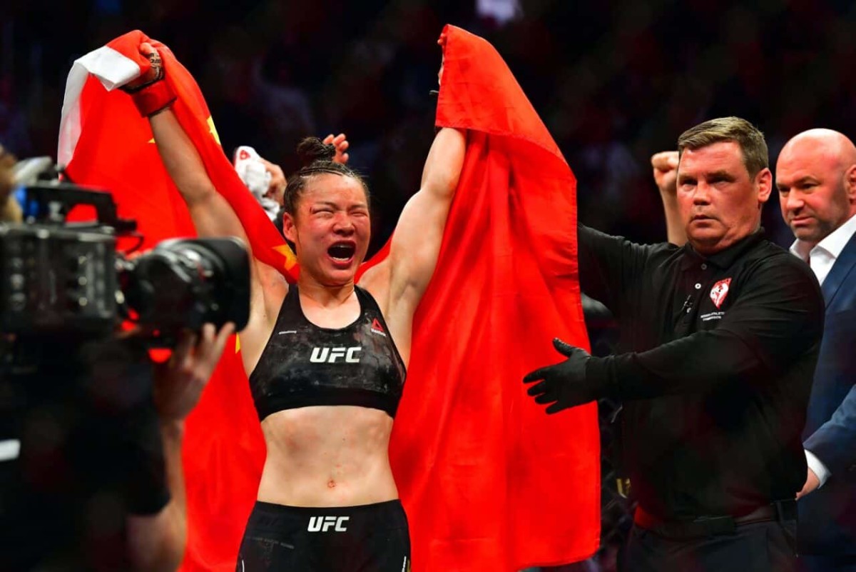 Mar 7, 2020; Las Vegas, Nevada, USA; Weili Zhang (red gloves) celebrates beating Joanna Jedrzejczyk (blue gloves) during UFC 248 at T-Mobile Arena. Mandatory Credit: Stephen R. Sylvanie-USA TODAY Sports