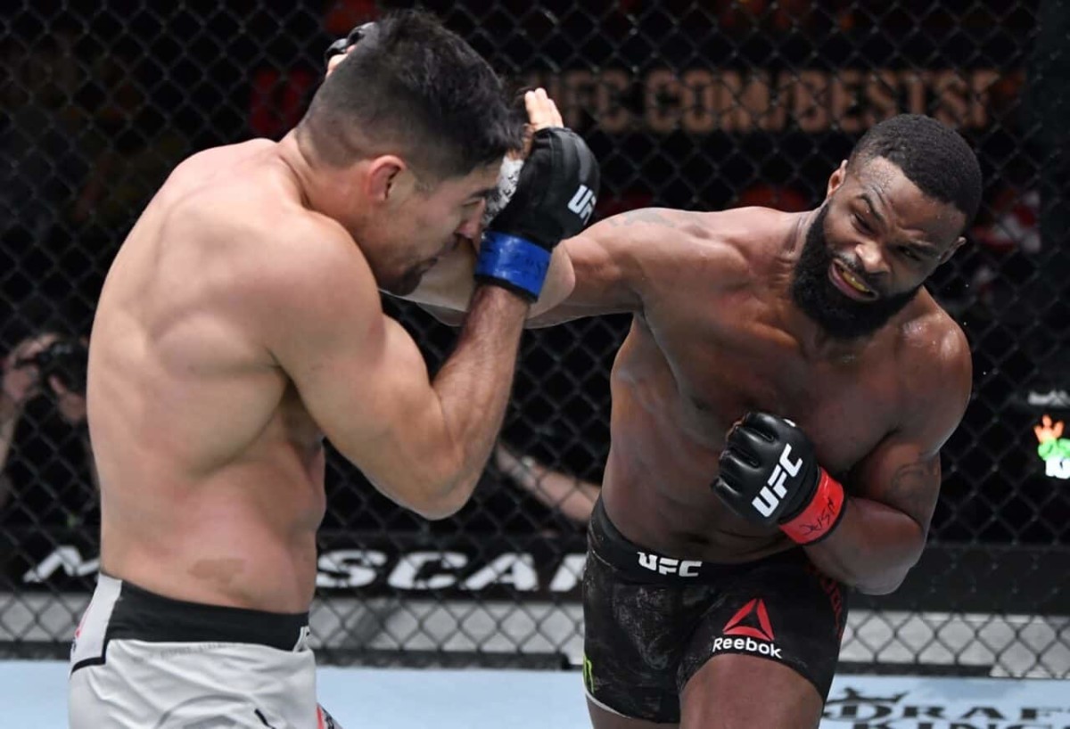 Mar 27, 2021; Las Vegas, NV, USA;    Tyron Woodley punches Vicente Luque in their welterweight fight during the UFC 260 event at UFC APEX on March 27, 2021 in Las Vegas, Nevada. Mandatory Credit: Jeff Bottari/Handout Photo via USA TODAY Sports