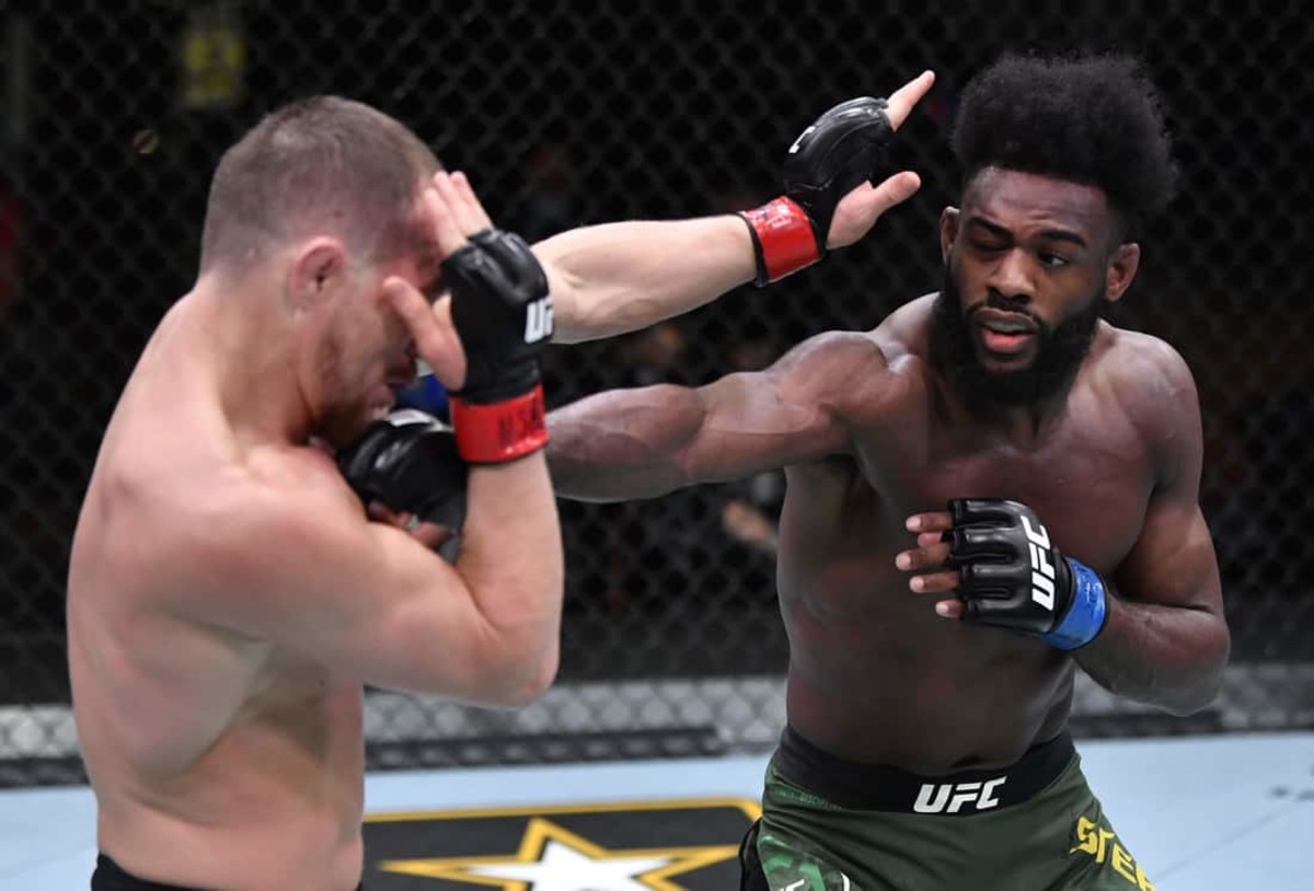 Mar 6, 2021; Las Vegas, NV, USA; Aljamain Sterling punches Petr Yan of Russia in their UFC bantamweight championship fight during the UFC 259 event at UFC APEX on March 06, 2021 in Las Vegas, Nevada.  Mandatory Credit: Jeff Bottari/Handout Photo via USA TODAY Sports